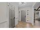 Bright foyer with modern lighting, neutral paint, and wood-look flooring, and front door at 2108 Rangecrest Rd, Raleigh, NC 27612