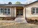 Inviting front entrance with a decorative wreath, brick accents, and fresh landscaping at 2108 Rangecrest Rd, Raleigh, NC 27612