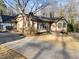 Tan single-story home with a well-maintained lawn, mature landscaping and a cozy front porch at 2108 Rangecrest Rd, Raleigh, NC 27612