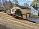 Two-car garage with an adjacent lawn and landscaping at 2108 Rangecrest Rd, Raleigh, NC 27612