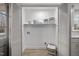 Convenient laundry room with shelving for storage and organization, complemented by modern design elements at 2108 Rangecrest Rd, Raleigh, NC 27612