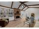 Spacious living room featuring a cozy fireplace, beamed ceilings, and built-in shelving at 2108 Rangecrest Rd, Raleigh, NC 27612