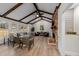 Bright living room with beamed ceilings, a brick fireplace, and ample seating at 2108 Rangecrest Rd, Raleigh, NC 27612
