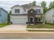 Charming two-story home featuring a brick facade, attached garage, and a well-maintained lawn at 2114 Cherry Creek Rd, Haw River, NC 27258