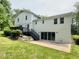 Backyard of the house, with a deck, stairs, lawn and large sliding doors at 2115 Port Royal Rd, Raleigh, NC 27609