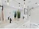 Modern bathroom featuring double sinks, quartz countertop, sleek fixtures, and a frameless glass shower at 2115 Port Royal Rd, Raleigh, NC 27609