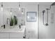 Modern bathroom featuring double sinks, quartz countertop, sleek fixtures, and a frameless glass shower at 2115 Port Royal Rd, Raleigh, NC 27609