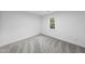 Cozy bedroom with soft carpet and a window with lush green views at 2115 Port Royal Rd, Raleigh, NC 27609