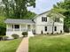 Charming white home with black shutters, manicured lawn, and inviting walkway at 2115 Port Royal Rd, Raleigh, NC 27609