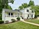 Beautiful home featuring a landscaped front yard and inviting porch with black metal railings at 2115 Port Royal Rd, Raleigh, NC 27609