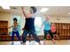 Fitness room with hard wood flooring, full sized windows and storage at 2115 Port Royal Rd, Raleigh, NC 27609