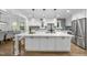 Stunning updated kitchen with a large island, modern pendant lighting, and stainless steel appliances at 2115 Port Royal Rd, Raleigh, NC 27609