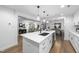 Bright kitchen boasts a large island with a modern faucet, stainless steel appliances, and open views to living spaces at 2115 Port Royal Rd, Raleigh, NC 27609