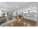 Open-concept living room flows into kitchen and dining area, featuring hardwood floors and bright spaces at 2115 Port Royal Rd, Raleigh, NC 27609