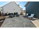 Beautiful stone patio with comfortable seating, lounge chairs, and a serene outdoor ambiance at 2128 Arborwood Dr, Durham, NC 27705