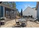 Relaxing outdoor patio with an umbrella-shaded dining set, grill, and adjacent screened-in porch at 2128 Arborwood Dr, Durham, NC 27705