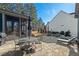 Outdoor living with a stone patio, dining set, grilling area, and a screened porch for relaxing at 2128 Arborwood Dr, Durham, NC 27705