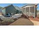Elegant outdoor patio with stone flooring, lush landscaping, and a screened porch for enjoying the backyard views at 2128 Arborwood Dr, Durham, NC 27705