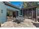 Outdoor dining and living blend seamlessly on this stone patio adjoining the screened porch, perfect for relaxing and entertaining at 2128 Arborwood Dr, Durham, NC 27705
