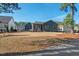 Expansive backyard featuring lush lawn and a screened porch, ideal for relaxation and outdoor enjoyment at 2128 Arborwood Dr, Durham, NC 27705