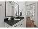 Stylish bathroom featuring a framed mirror, dark granite countertop, and white cabinets at 2128 Arborwood Dr, Durham, NC 27705