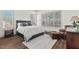 Inviting bedroom with plantation shutters, wood-look flooring, and neutral tones at 2128 Arborwood Dr, Durham, NC 27705