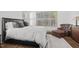 Beautiful bedroom featuring hardwood floors, white walls, upholstered bed, and bright natural light at 2128 Arborwood Dr, Durham, NC 27705
