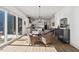 Sunlit breakfast room featuring hardwood floors, a modern chandelier, and sliding glass doors to the backyard at 2128 Arborwood Dr, Durham, NC 27705