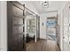 Inviting entryway with barn doors, wood-look floors, and access to the garage at 2128 Arborwood Dr, Durham, NC 27705