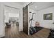 Workout room with sliding barn door, weights, and access to the kitchen at 2128 Arborwood Dr, Durham, NC 27705