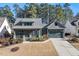 Charming home featuring a front porch, manicured lawn, and attached garage at 2128 Arborwood Dr, Durham, NC 27705