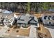 Aerial shot of a Craftsman-style home featuring a cozy front porch, well-maintained landscaping, and a spacious driveway at 2128 Arborwood Dr, Durham, NC 27705