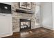 Close-up of stone fireplace with floating mantel and patio access at 2128 Arborwood Dr, Durham, NC 27705