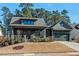 Charming home with a covered front porch, manicured lawn, and a two-car garage, blending comfort and curb appeal at 2128 Arborwood Dr, Durham, NC 27705