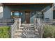 Inviting front porch with stone steps, a wooden door, and a cozy seating area at 2128 Arborwood Dr, Durham, NC 27705
