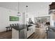 Spacious kitchen featuring a large island with black countertops and seating with open concept design at 2128 Arborwood Dr, Durham, NC 27705