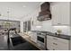 Modern kitchen with stainless steel appliances, white cabinets, and a stylish range hood at 2128 Arborwood Dr, Durham, NC 27705