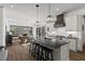 Open-concept kitchen with stainless steel appliances and a large center island with barstool seating at 2128 Arborwood Dr, Durham, NC 27705
