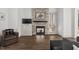 Bright living room with stone fireplace, wood-look floors, and patio access at 2128 Arborwood Dr, Durham, NC 27705