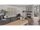 Bright and airy living room with a stone fireplace, comfortable seating, and access to the outdoor deck at 2128 Arborwood Dr, Durham, NC 27705