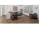 Comfortable living room with L-shaped couch, ottoman, and wood-look floors at 2128 Arborwood Dr, Durham, NC 27705