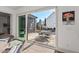 A glimpse through a large sliding glass door to the patio, complete with outdoor furniture and lush landscaping at 2128 Arborwood Dr, Durham, NC 27705