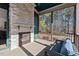 Relaxing screened porch with stone fireplace, seating area, and wooded views at 2128 Arborwood Dr, Durham, NC 27705