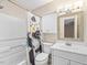This bathroom features a white sink and vanity, a toilet, a tub with a shower, and a decorative shower curtain at 228 Finley Forest Dr, Chapel Hill, NC 27517