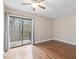 This bedroom features wood floors, a ceiling fan, and a sliding glass door to the outside at 228 Finley Forest Dr, Chapel Hill, NC 27517