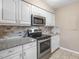 Updated kitchen with stainless steel appliances, granite countertops and white cabinets at 228 Finley Forest Dr, Chapel Hill, NC 27517
