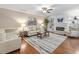 Cozy living room with a fireplace, ceiling fan, plush seating, and stylish decor at 228 Finley Forest Dr, Chapel Hill, NC 27517