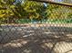 View of the community tennis courts through a chain-link fence at 228 Finley Forest Dr, Chapel Hill, NC 27517