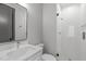 Sleek bathroom design with modern vanity, mirror, and a glass-enclosed shower with stylish fixtures at 228 Woodsborough Pl, Raleigh, NC 27601