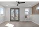 This bedroom has light colored hardwood floors, an accent wall, and French doors at 228 Woodsborough Pl, Raleigh, NC 27601